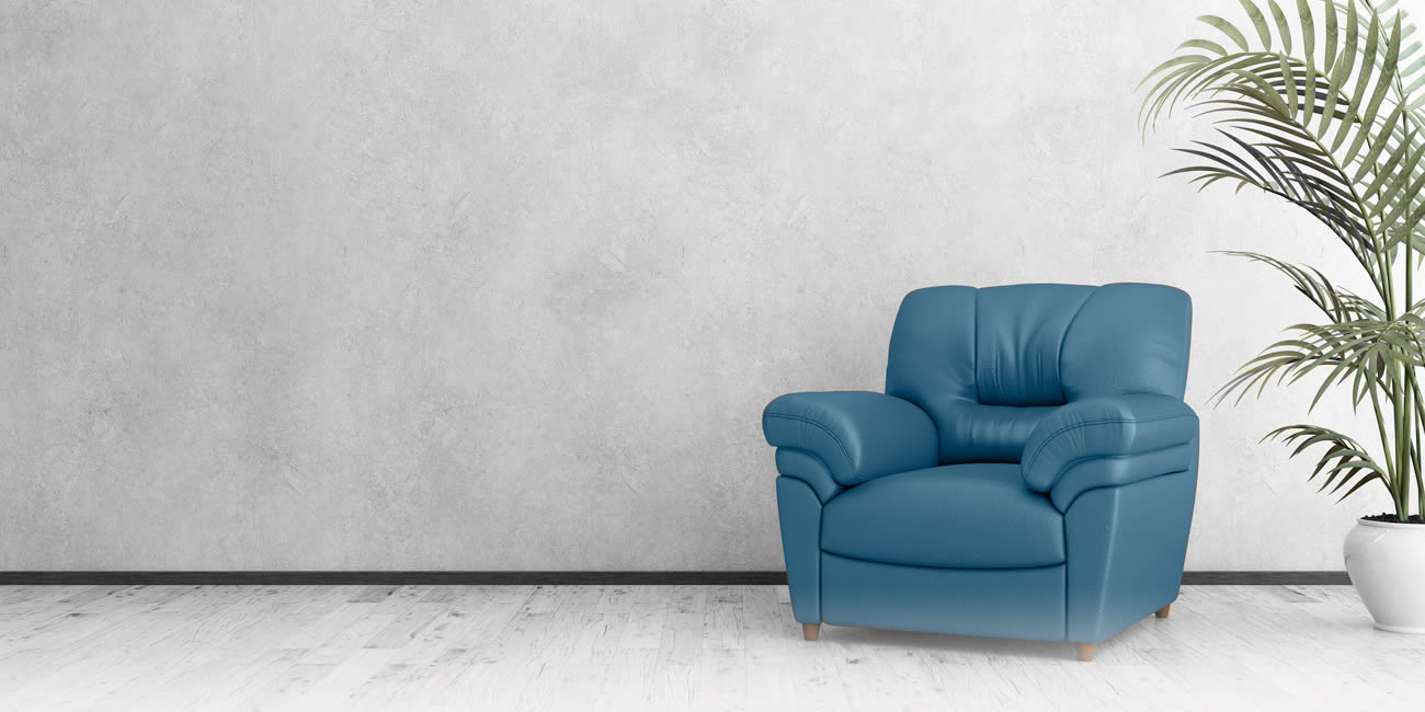 Large blue couch against light grey wall
